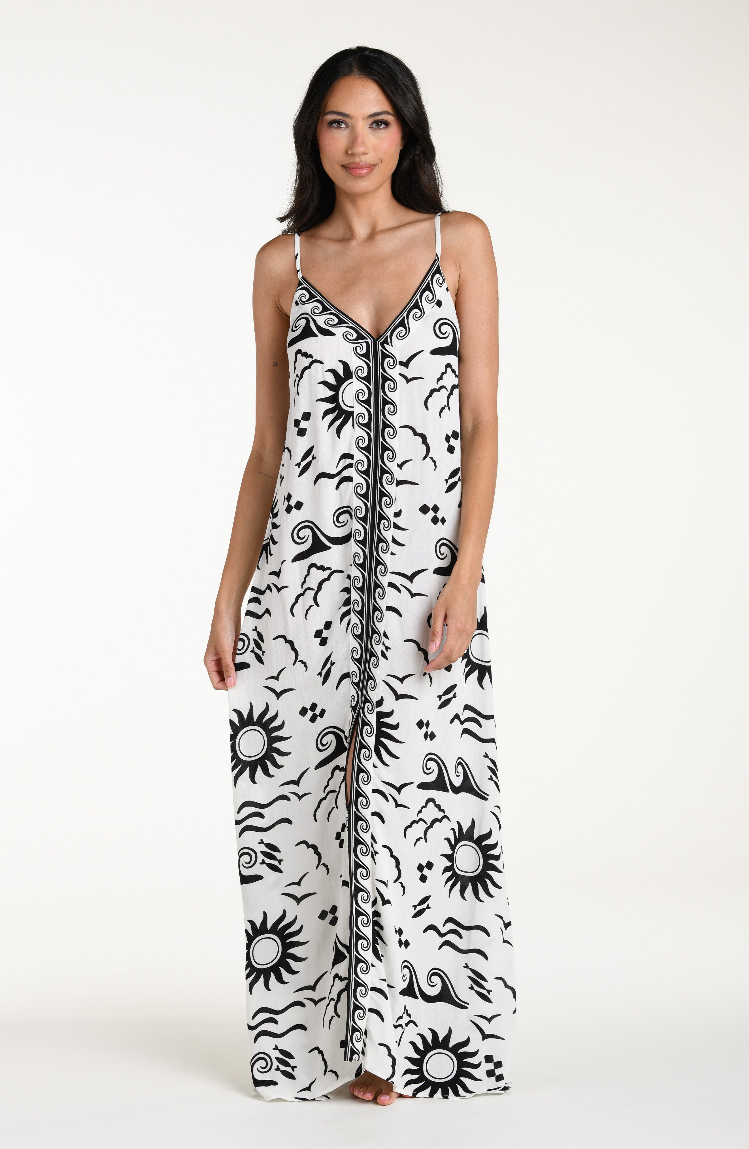 Woman wearing a black and white patterned maxi dress against a white background