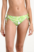 Woman wearing a green and white patterned bikini bottom on a white background