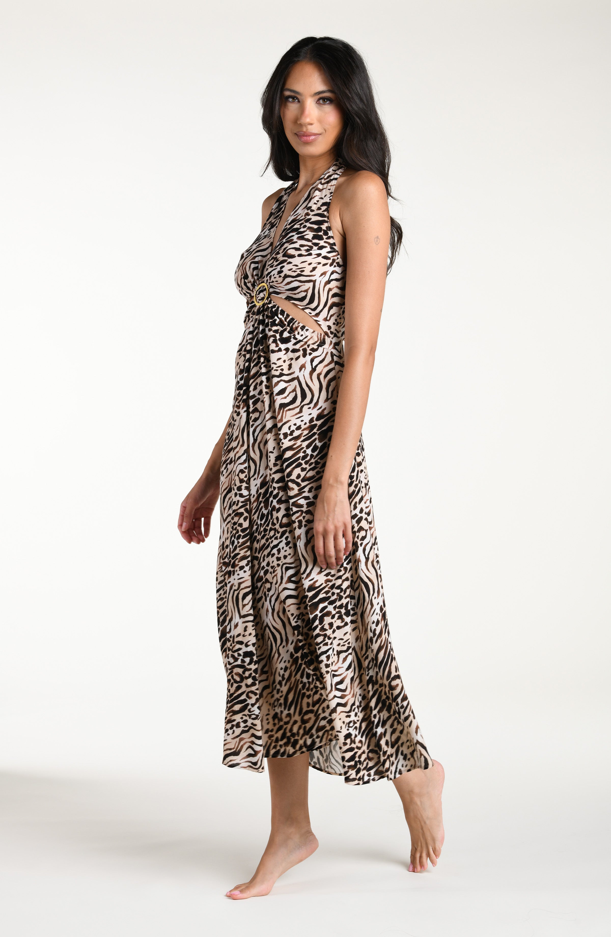 Woman wearing a zebra printed maxi dress cover up against a white background