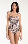 Woman wearing a zebra print tankini top and matching bottom against a white background