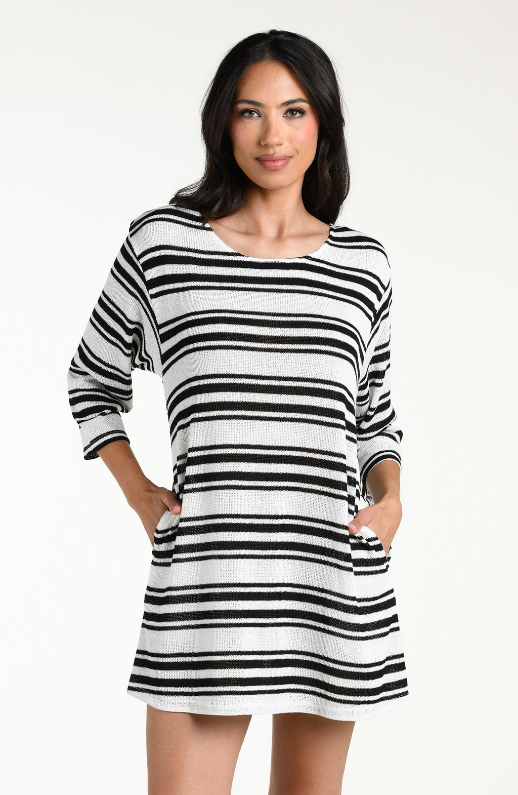 Woman wearing a black and white striped tunic cover up against a white background