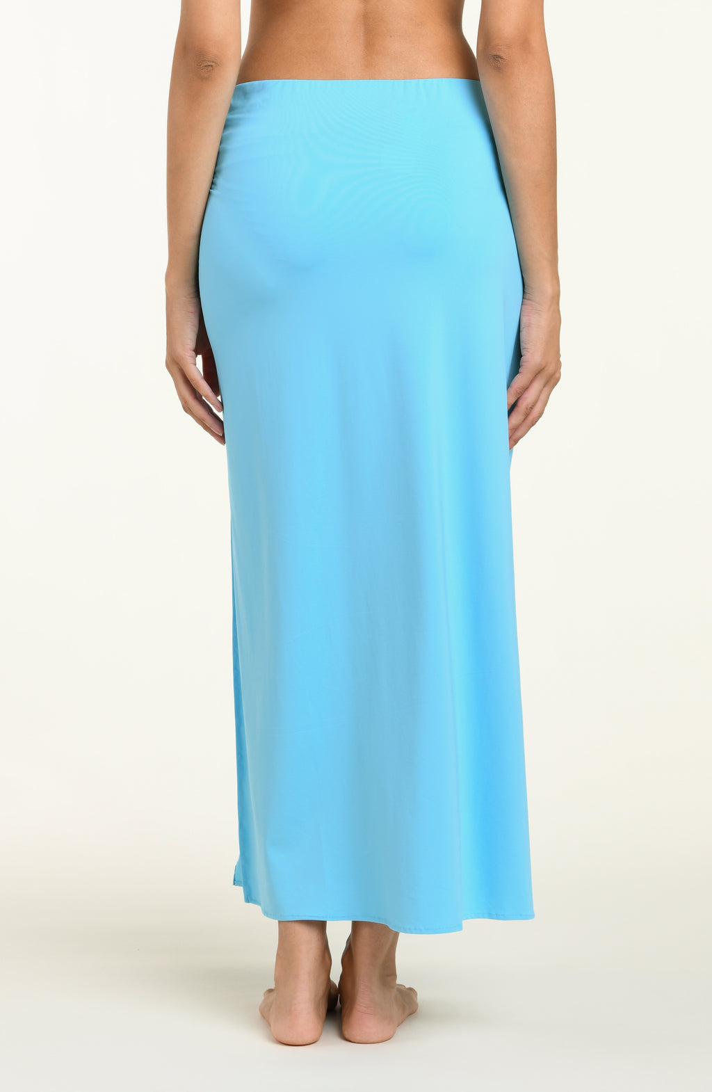 Light blue cover up skirt worn by a person on a white background