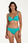 Front image of model wearing a calypso (turquoise) colored bikini top with thin adjustable straps and a plunging neckline. This is paired with a matching bikini bottom.
