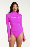 Woman wearing a violet colored long-sleeve overlay top with a high neckline. This is paired over a matching one piece swimsuit against a white background.
