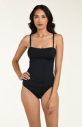 Woman wearing a black one piece swimsuit on a white background