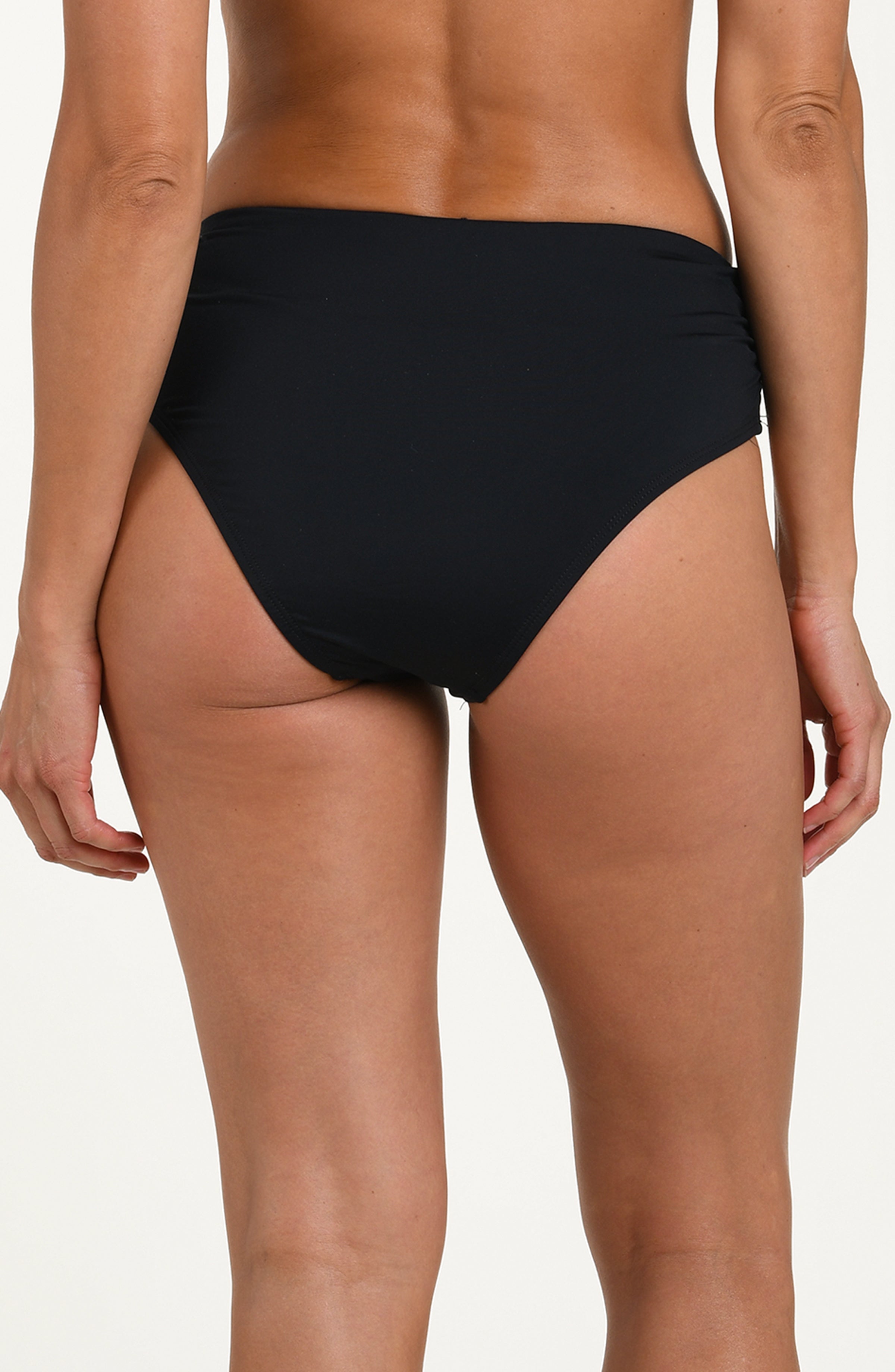 Back image of model wearing a black bikini bottom with ruched sides and full coverage fit. 