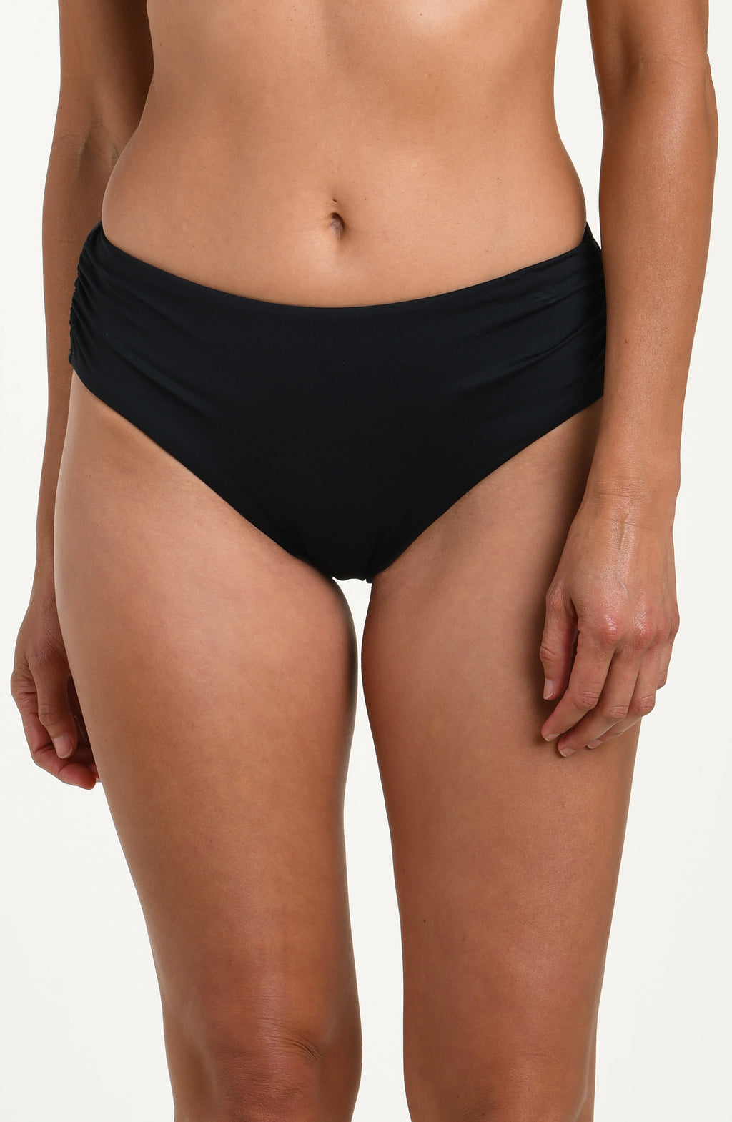 Front image of model wearing a black bikini bottom with ruched sides and full coverage fit. 