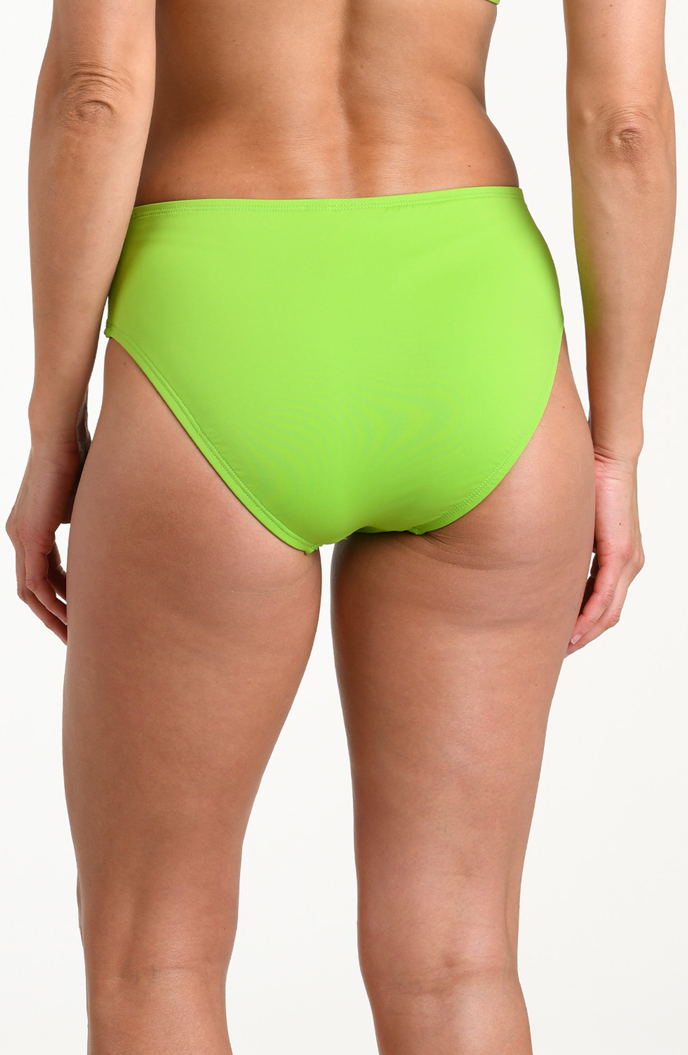 Woman wearing an apple green mid-waist bottom against a white background.