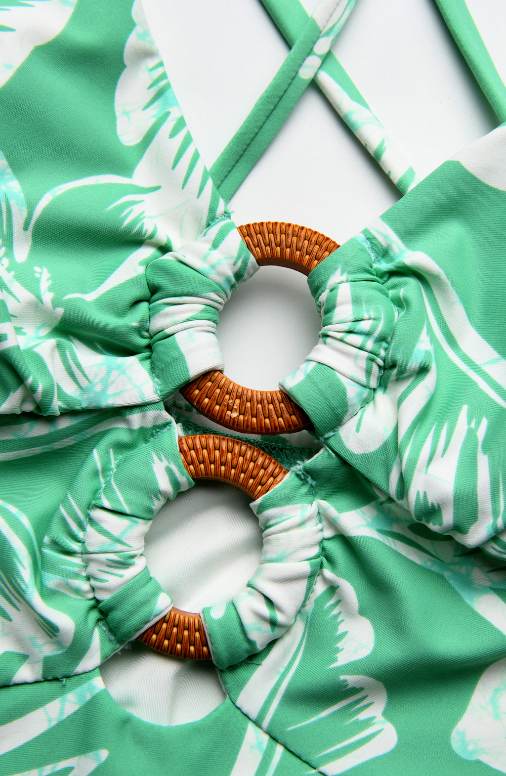 Close-up image of a green and white lace front with wooden ring detail.
