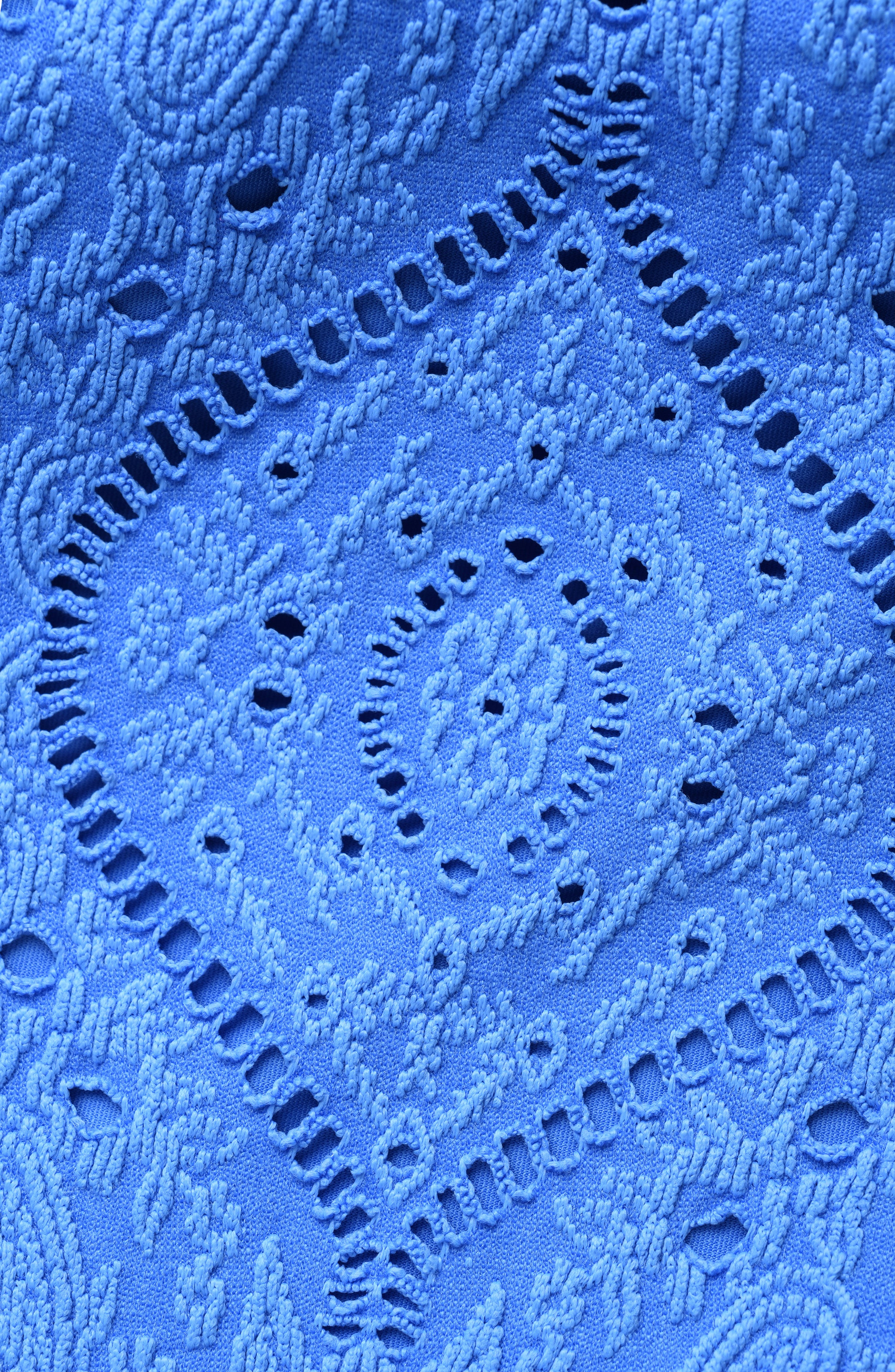 Close-up of blue lace fabric with intricate patterns