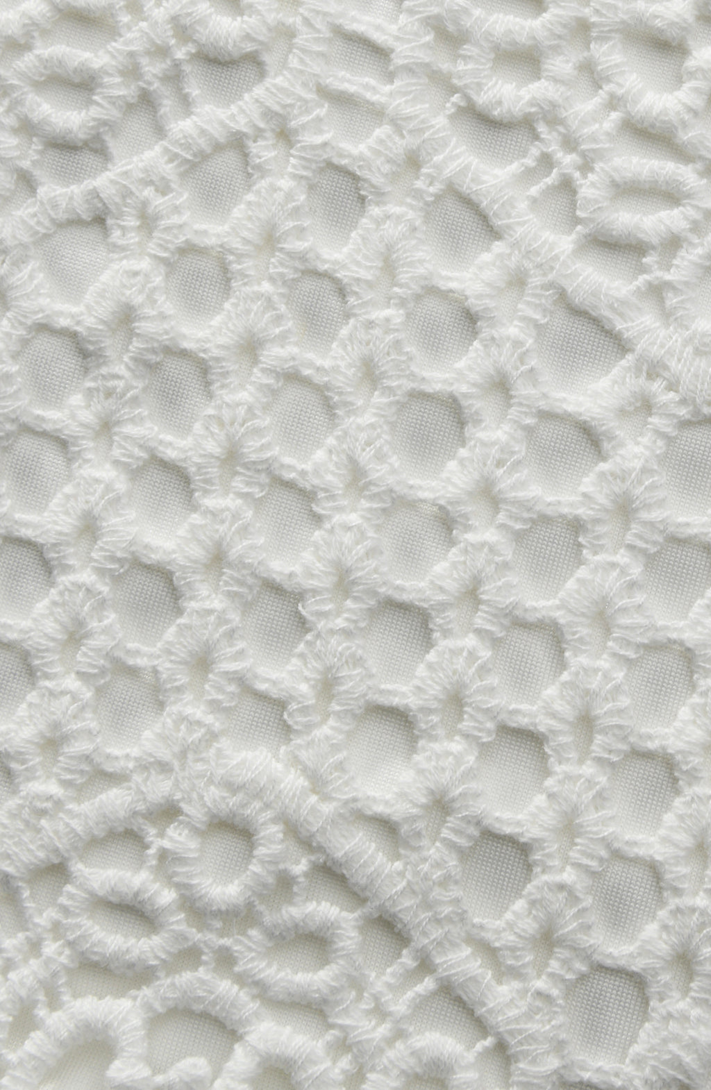 Close-up of a textured white surface with a lattice pattern