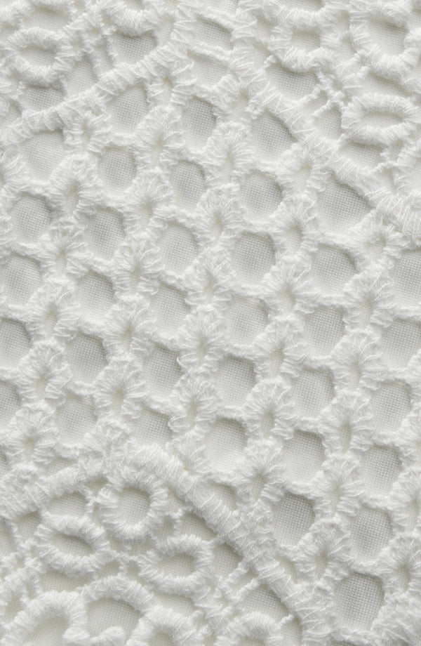 Close-up of a textured white surface with a lattice pattern
