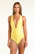 Woman wearing a bright yellow one piece swimsuit with center front detail against a white background. 