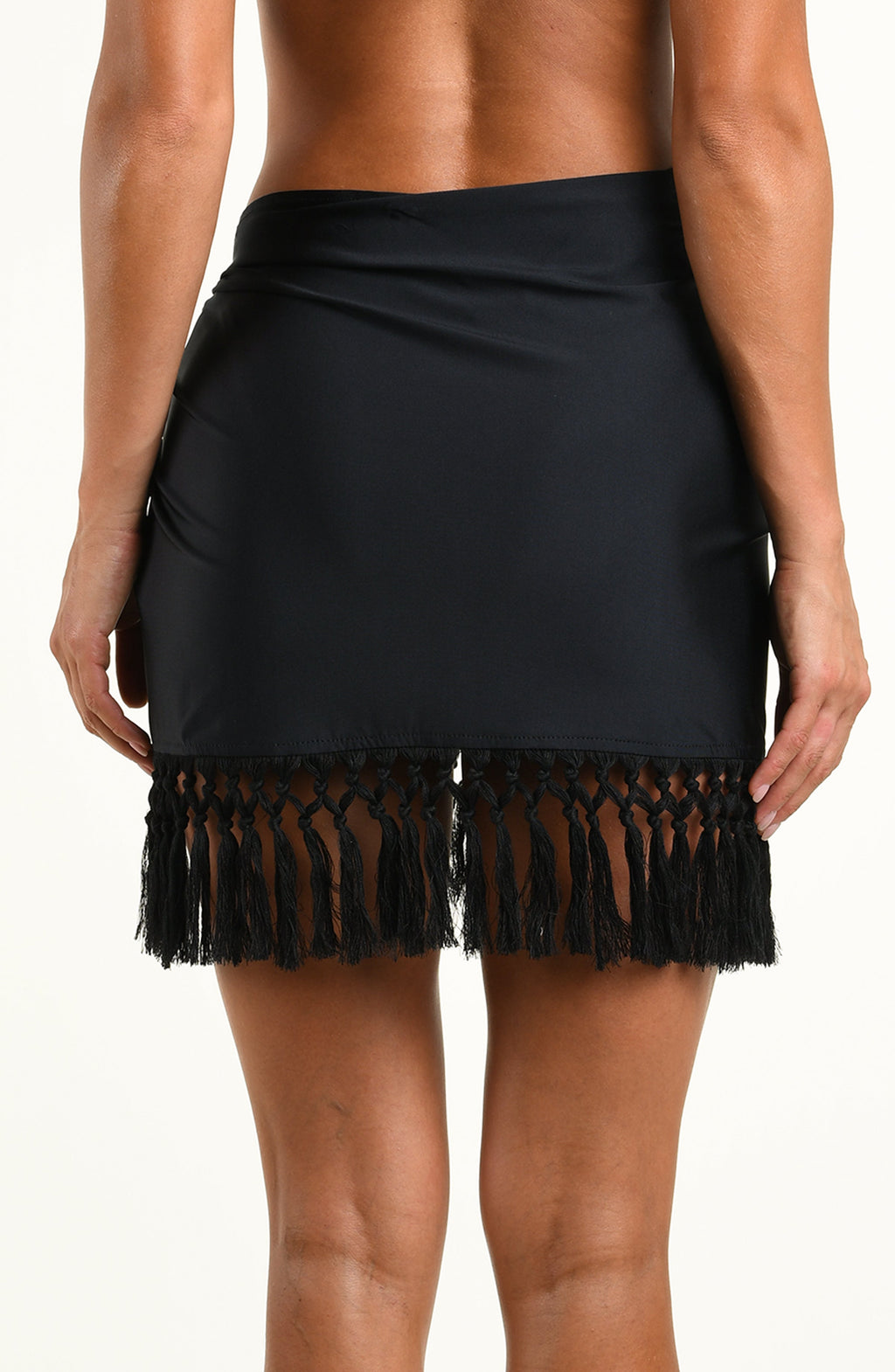 Woman wearing a solid black short sarong against a white background. 
