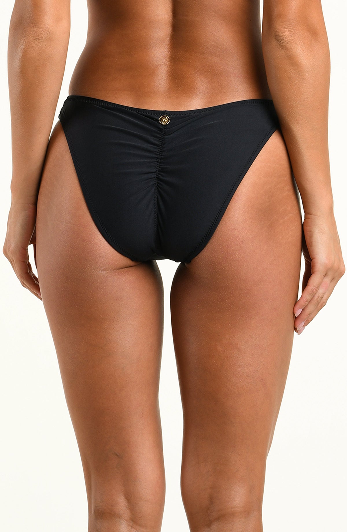 A model wearing a solid black bikini bottom, against a white background.