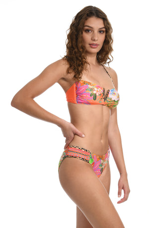 
            
                Load image into Gallery viewer, Model is wearing an orange multicolored tropical printed bandeau bikini swimsuit top from our In A Trance collection. 
            
        