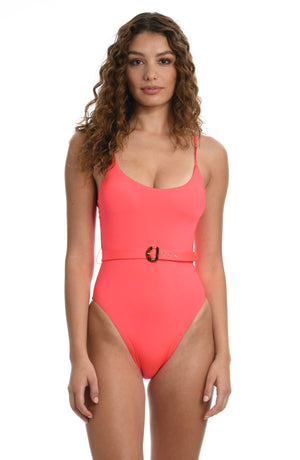Model is wearing a solid watermelon colored over the shoulder one piece swimsuit from our Wanderlust Solids collection.