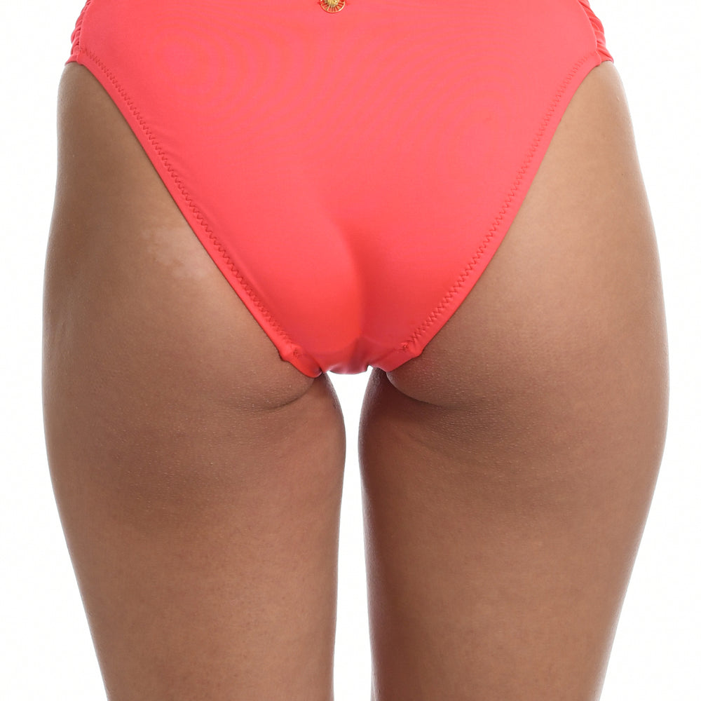 
                  
                    Model is wearing a solid watermelon colored side tie hipster bikini bottom from our Wanderlust Solids collection.
                  
                