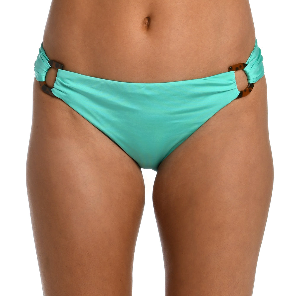 Model is wearing a solid seafoam green colored side tie hipster bikini bottom from our Wanderlust Solids collection.