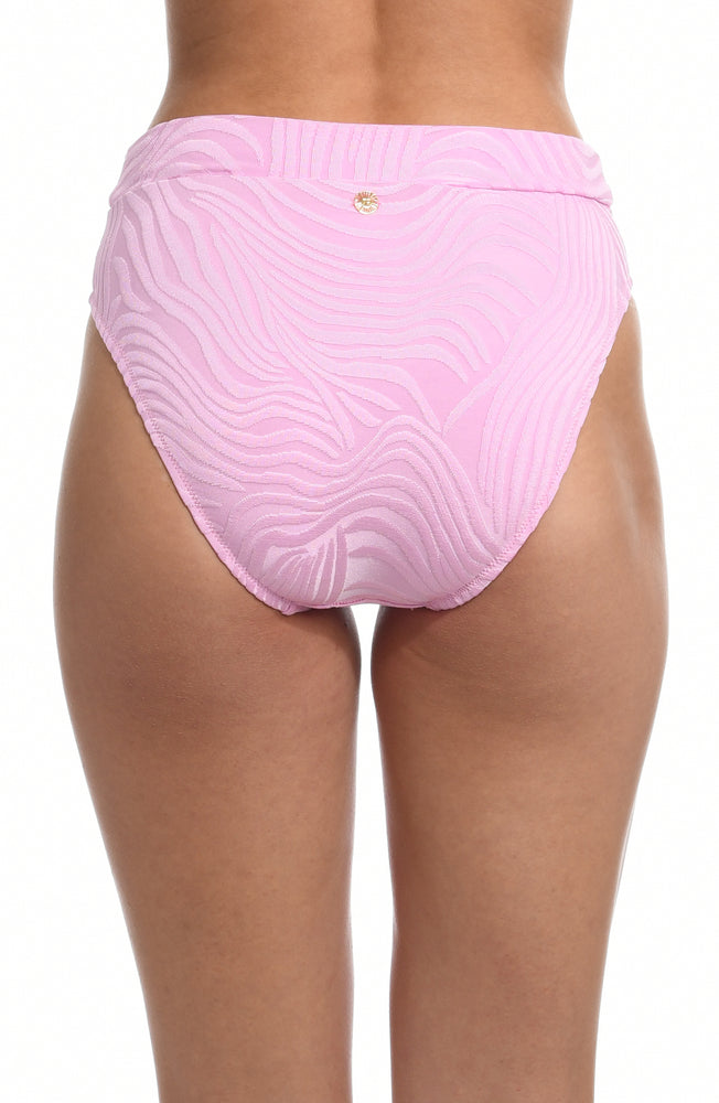 Model is wearing a light pink high waist swimsuit bottom with a gentle all over swirl print from our Groovy Swirl collection.