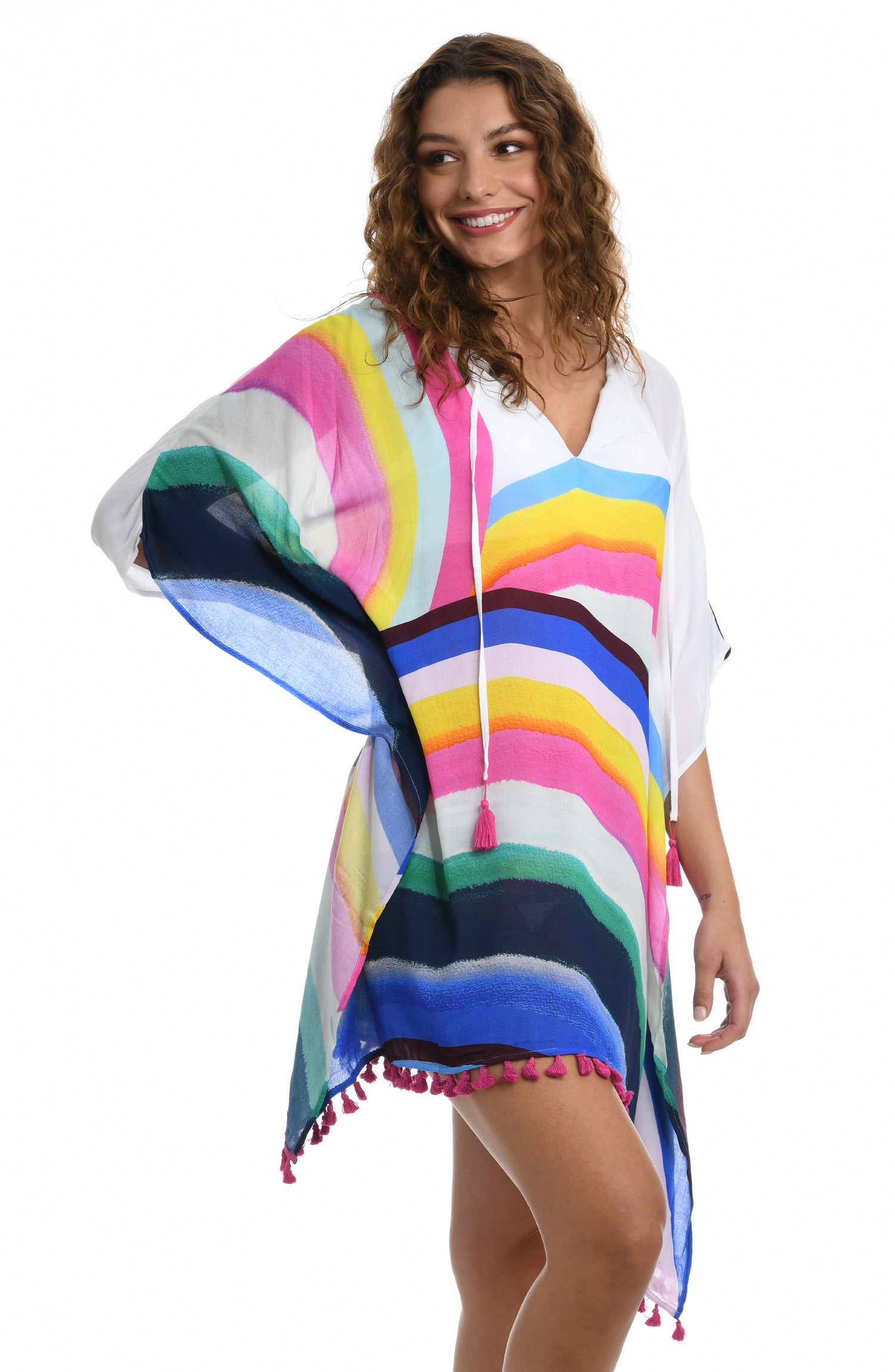 Model is wearing a white v-neck tunic swimsuit cover up with a vibrant rainbow striped print from our Retro Rainbow collection.