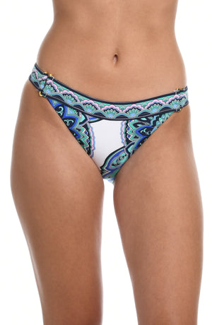 Model is wearing a white french cut swimsuit bottom with shades of a blue medallion all over print from our Mellow Medallion collection.