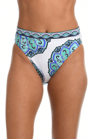 Model is wearing a white high waist swimsuit bottom with shades of a blue medallion all over print from our Mellow Medallion collection.