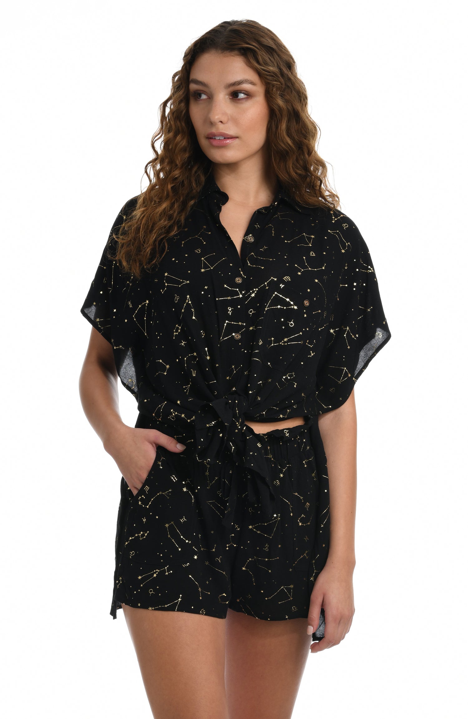 Model is wearing a solid black colored resort button down cover up shirt from our Zodiac collection.