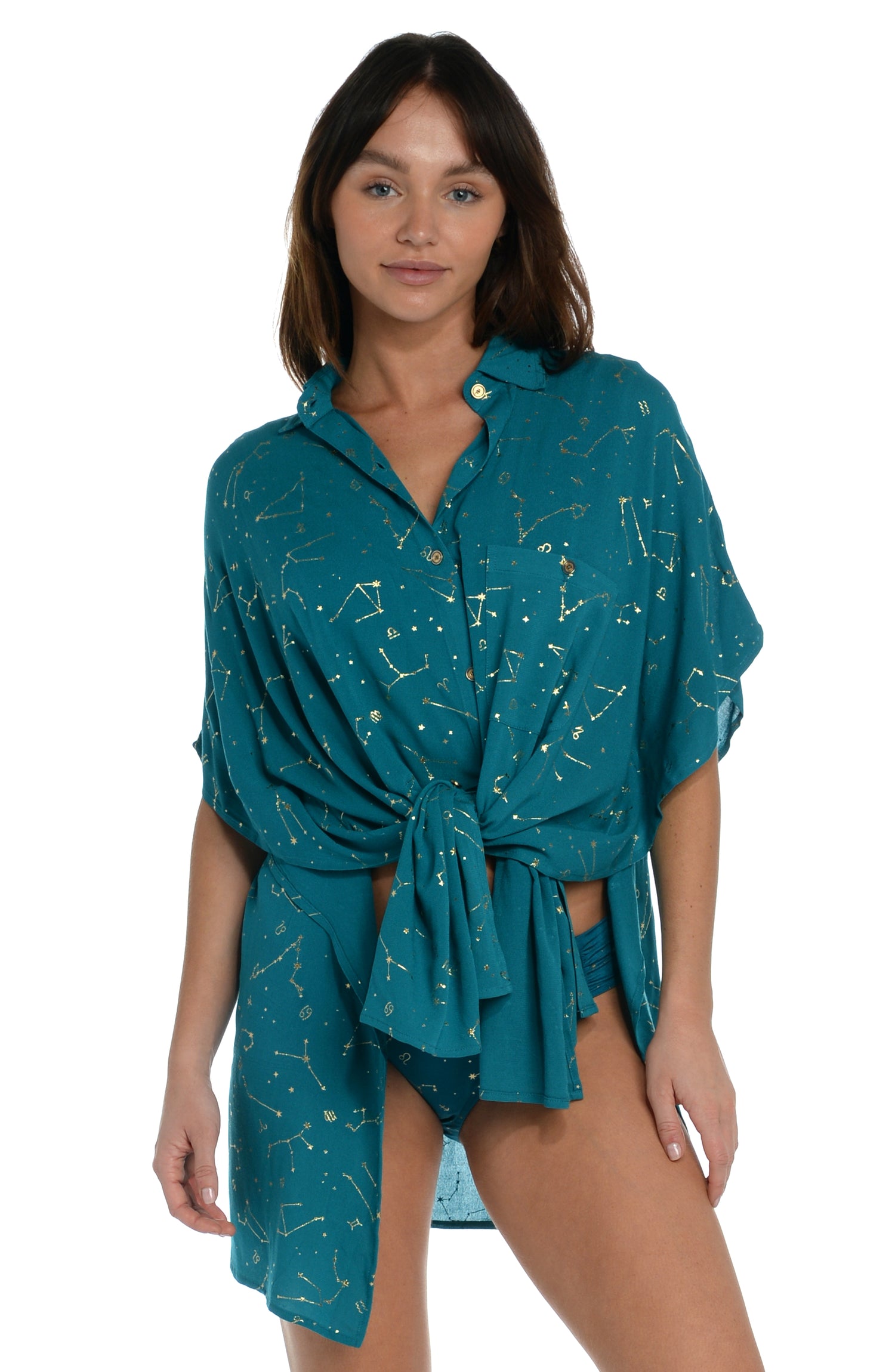 Model is wearing a solid teal colored resort button down cover up shirt from our Zodiac collection.