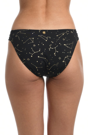 Model is wearing a solid black colored side shirred hipster bikini bottom from our Zodiac collection.