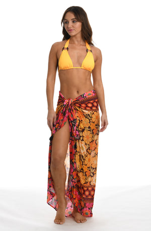 Model is wearing a yellow and pink multicolored retro inspired flower printed pareo wrap swimsuit cover up from our Flower Power collection.
