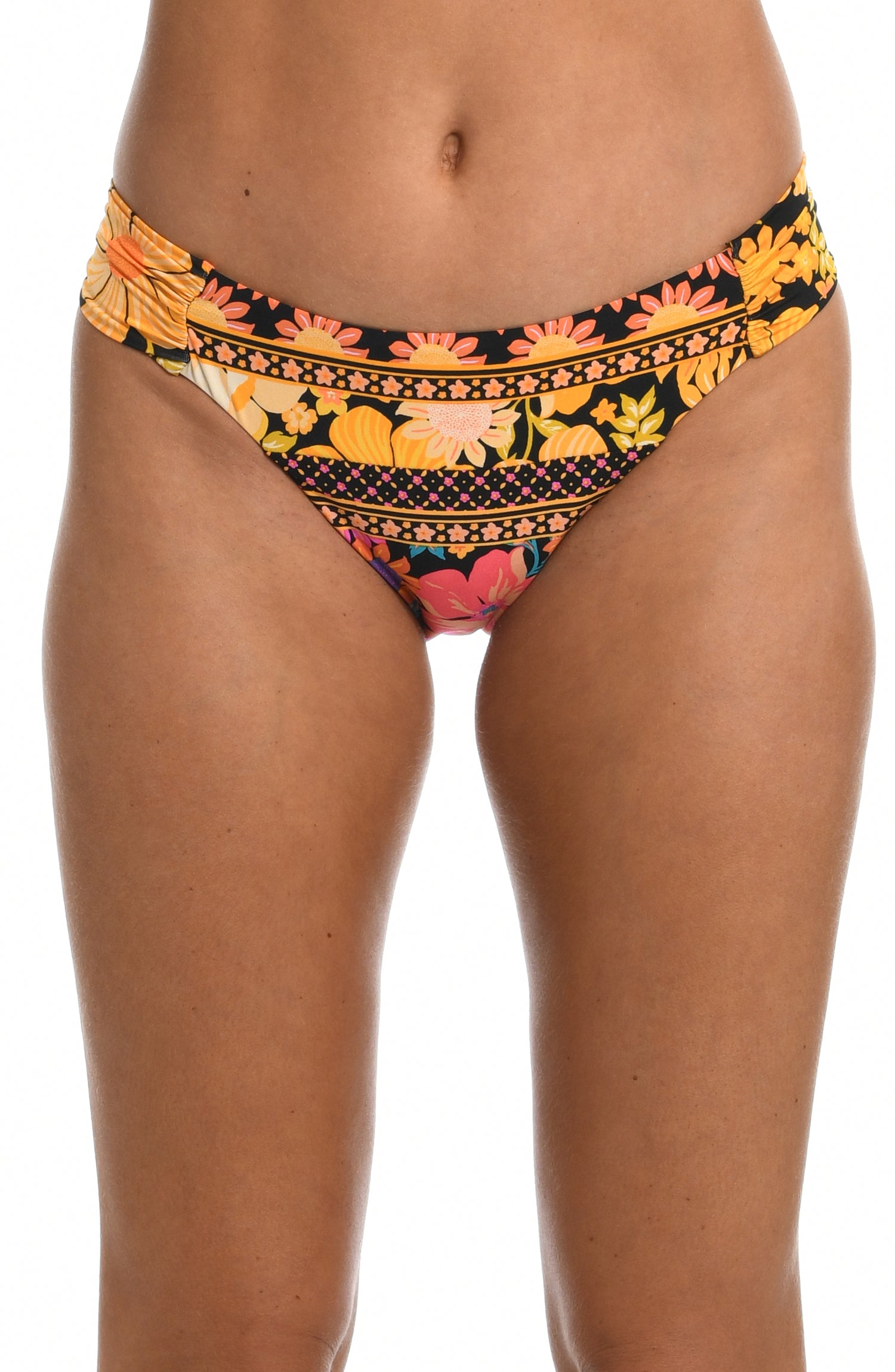 Model is wearing a yellow and pink multicolored retro inspired flower printed side shirred hipster swimsuit bottom from our Flower Power collection.