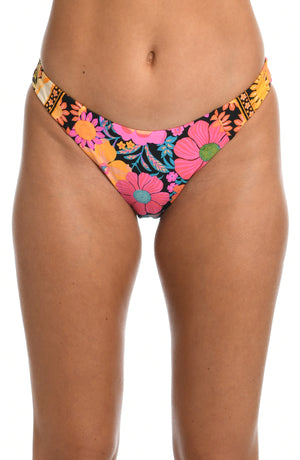 Model is wearing a yellow and pink multicolored retro inspired flower printed french cut bikini swimsuit bottom from our Flower Power collection.