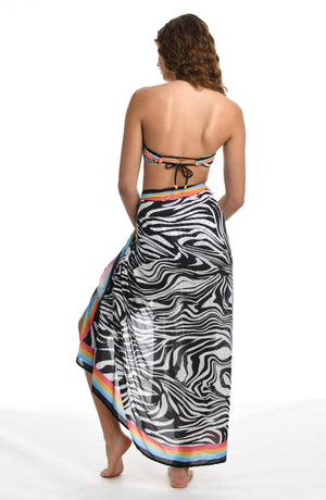 Model is wearing a black and white zebra printed pareo wrap swimsuit cover up from our Psychedelic Zebra collection.