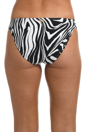 Model is wearing a black and white zebra printed side shirred hipster swimsuit bottom from our Psychedelic Zebra collection.