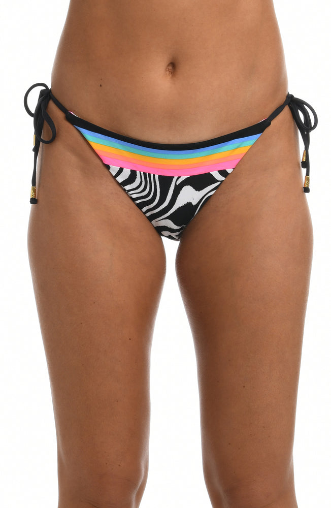 Model is wearing a black and white zebra printed side tie hipster swimsuit bottom from our Psychedelic Zebra collection.