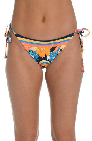 Model is wearing a bright multicolored floral swirl printed side tie hipster bikini bottom from our Love Swirl collection.