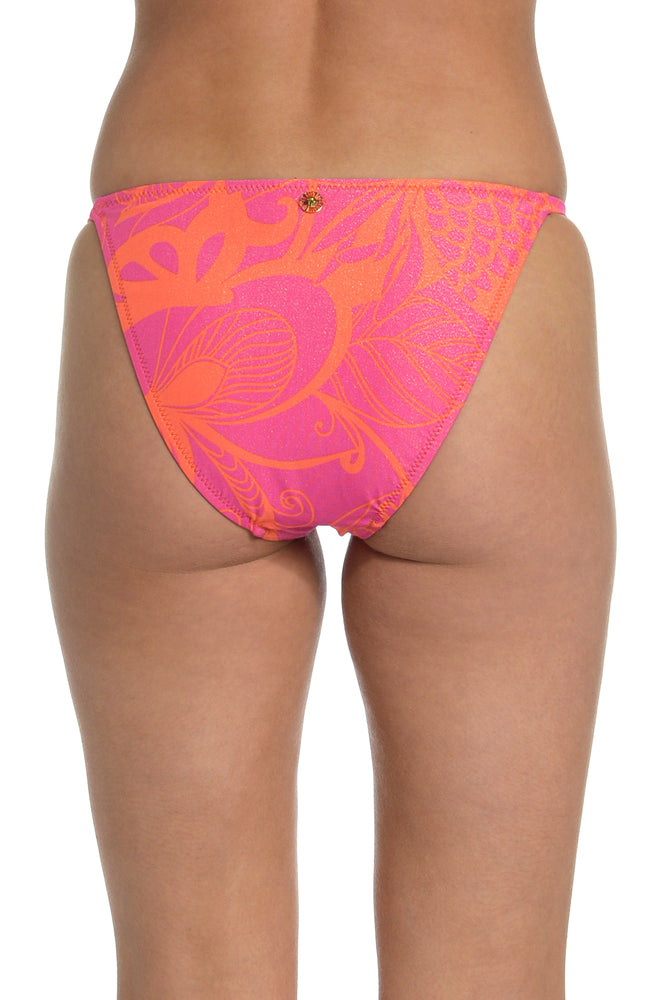 Model is wearing a pink and orange multicolored side tie hipster bikini bottom from our All A Flutter Collection.
