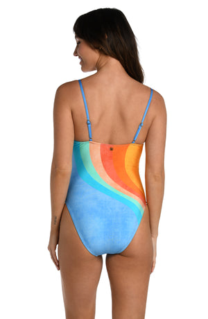 Model is wearing an orange and blue multicolored retro printed over the shoulder one piece swimsuit from our Mod Block collection.