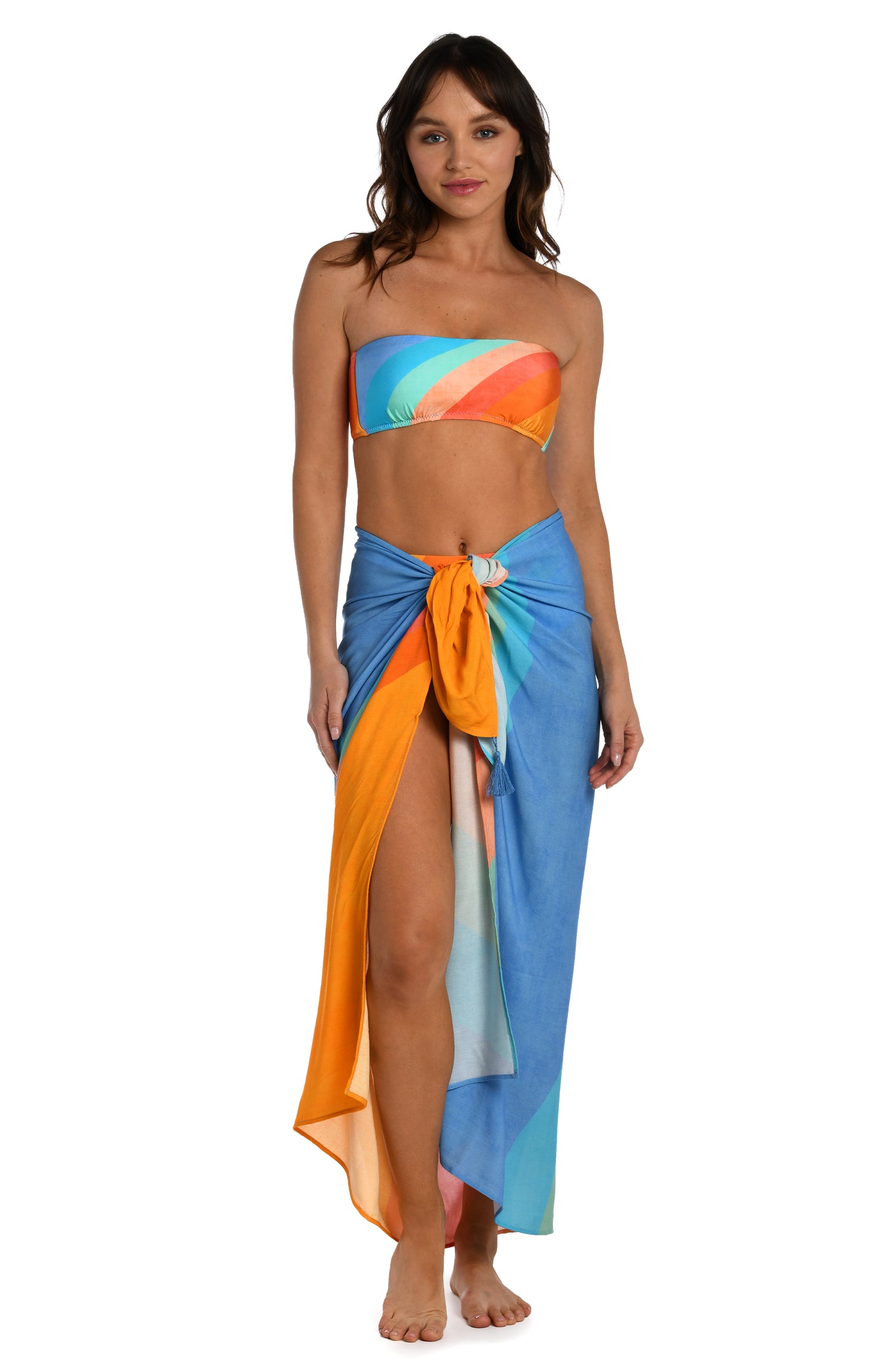 Model is wearing an orange and blue multicolored retro printed pareo wrap cover up from our Mod Block collection.