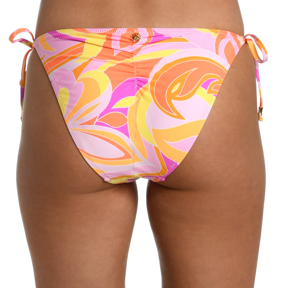 Model is wearing a pink, white, and orange multicolored retro printed side tie hipster bikini bottom from our Retro Swirl collection.