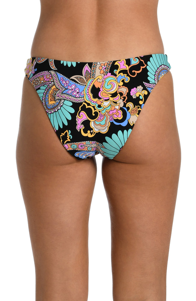 
            
                Load image into Gallery viewer, Model is wearing a black multicolored paisley printed reversible black french cut bikini bottom from our Paisley Patchwork collection.
            
        