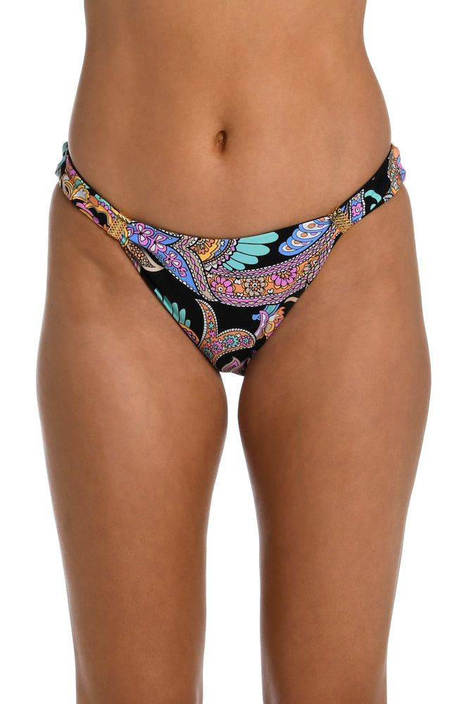 Model is wearing a black multicolored paisley printed reversible black french cut bikini bottom from our Paisley Patchwork collection.