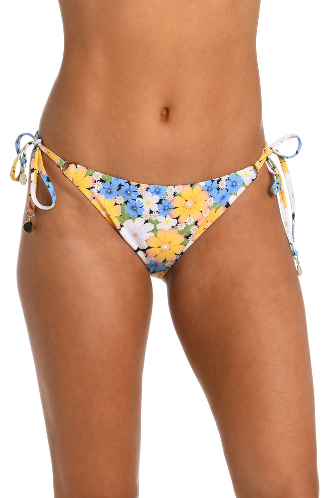 
            
                Load image into Gallery viewer, Model is wearing a multicolored daisy printed side tie hipster bikini bottom from our Daisy Daze collection.
            
        