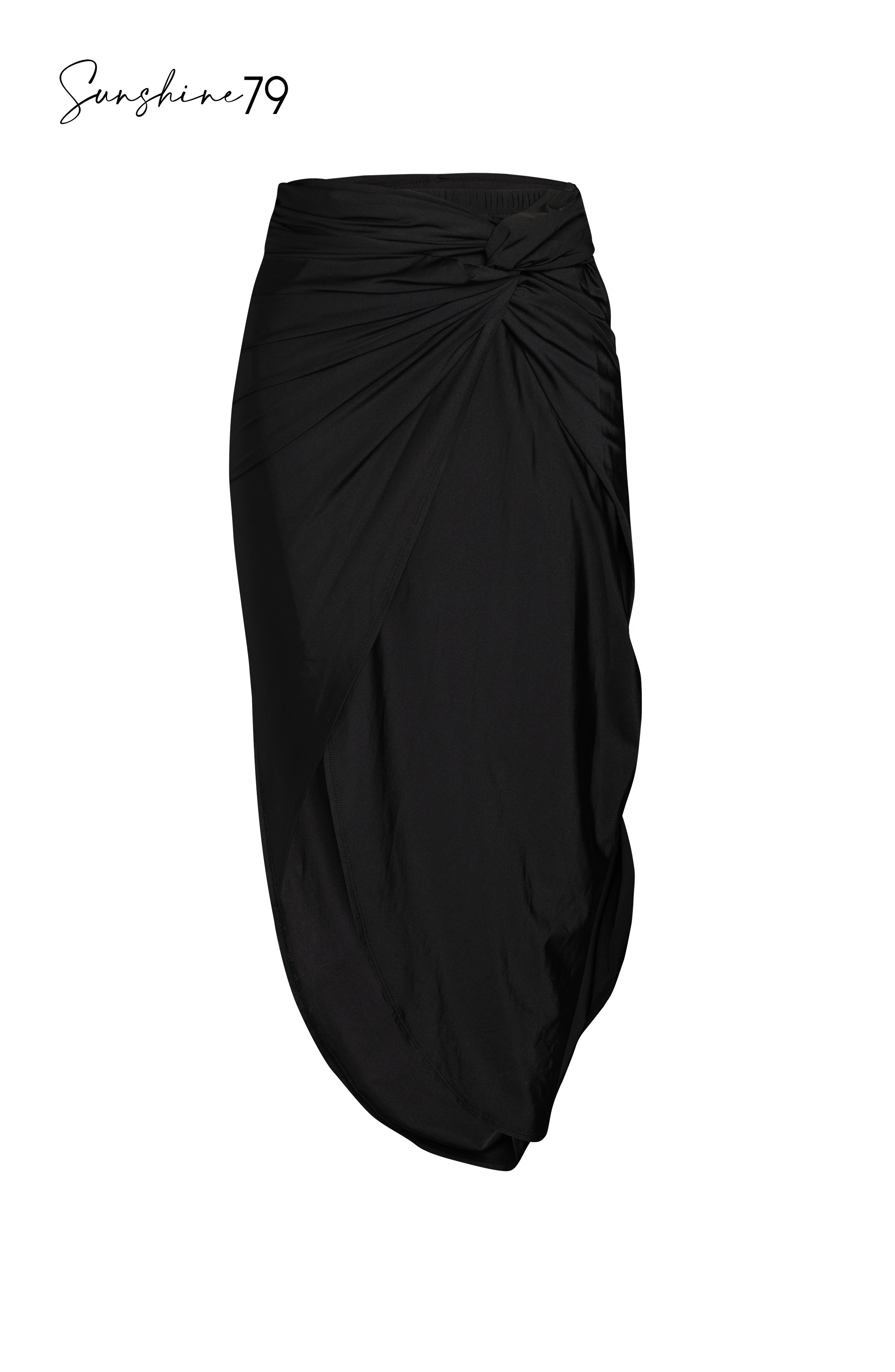 Model is wearing a solid black pull on faux pareo cover up wrap from our Sunshine 79 brand.