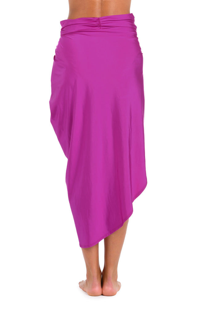 Back image of model wearing a Sunshine 79 Sunshine Solids Pull-On Faux Pareo Cover Up in Bright Violet.