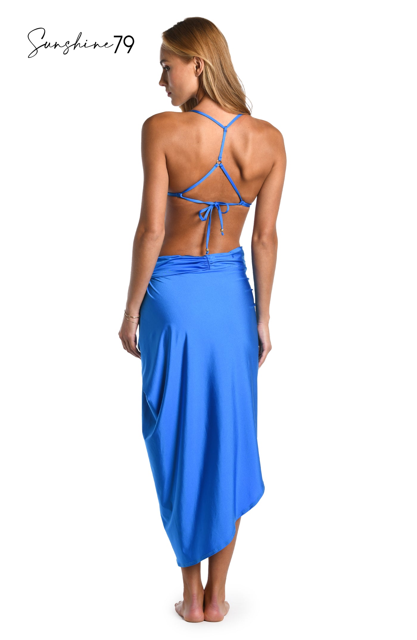 
                  
                    Model is wearing a solid cobalt blue colored pull on faux pareo wrap cover up from our Sunshine 79 brand.
                  
                