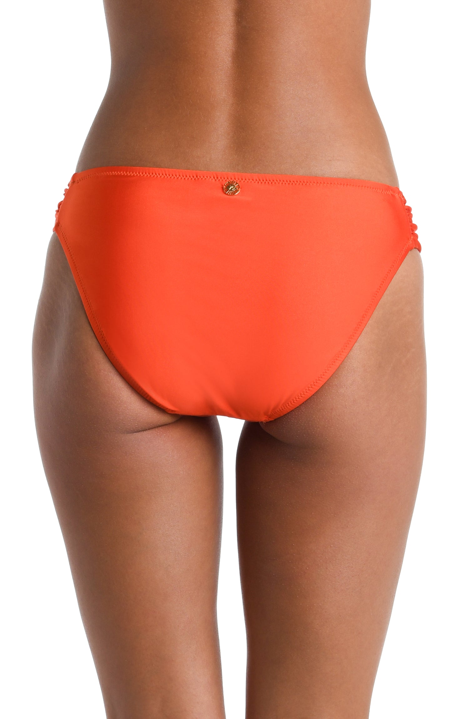 Model is wearing a solid vibrant orange colored Side Shirred Hipster Bottom