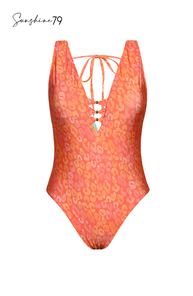 Model is wearing an orange multicolored tropical printed reversible plunge one piece swimsuit from our Sunshine 79 brand.