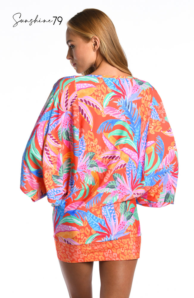 Model is wearing an orange multicolored tropical printed short sleeve tunic cover up from our Sunshine 79 brand.
